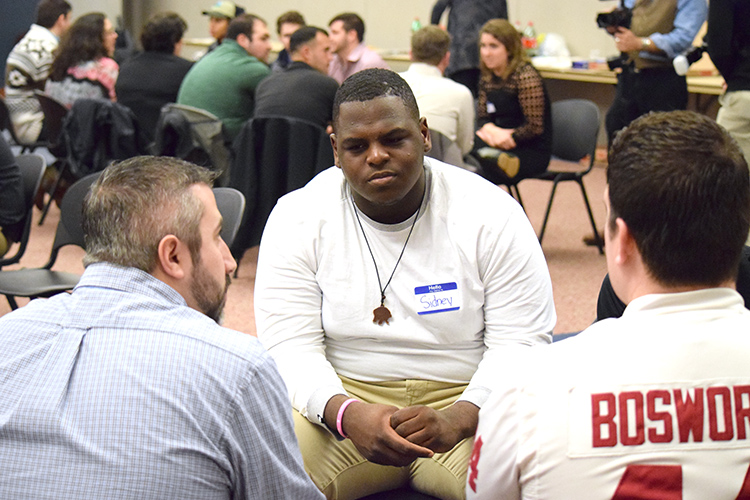 Sidney Jones, a journalism student at Southern, talks with sports reporters during the Journalism Alumni Night Nov. 30. | Jodie Mozdzer Gil photo. 
