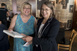 Cindy Simoneau, left, receives the Teacher of the Year award from SPIG teaching chair Liz Atwood, right, during a reception in Minneapolis Aug. 5. | Vern Williams photo