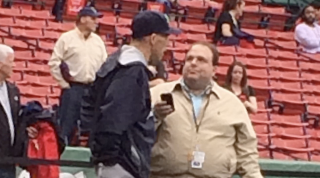 Photo of Dom Amore interviewing a coach after a game.