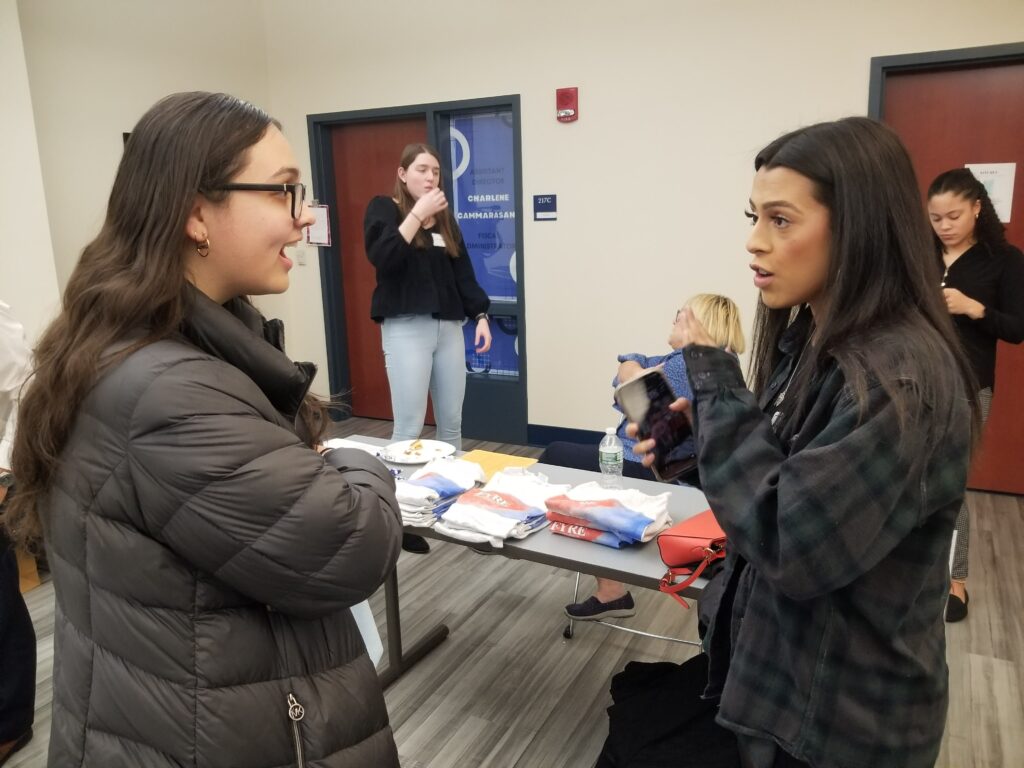 Two people talk during a networking event.