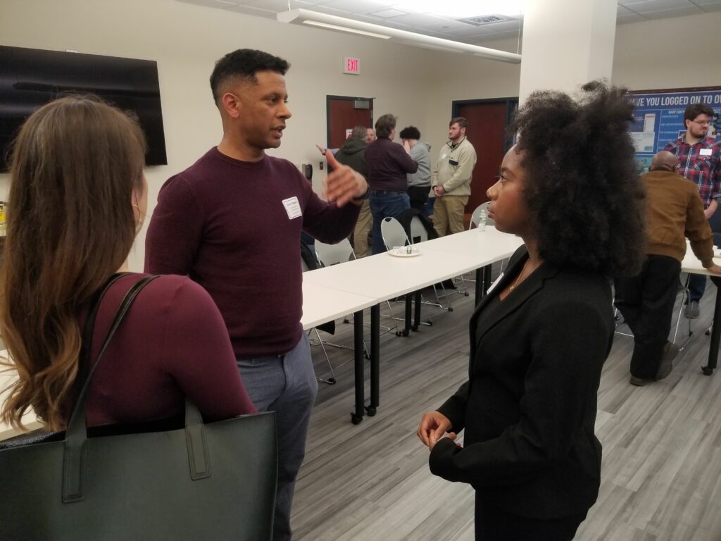 A group of people talk during a networking event.